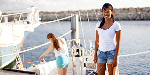 Two young females standing on a yacht